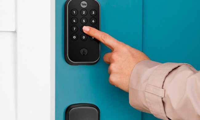 The Yale Assure Lock 2 Smart Lock Deadbolt keypad being used by someone.